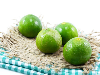 fresh lime and tablecloth on white background