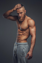 Shirtless muscular man with beard.