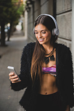 Young urban woman listening to music