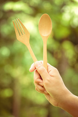 Woman hand and wooden spoon with filter effect retro vintage style