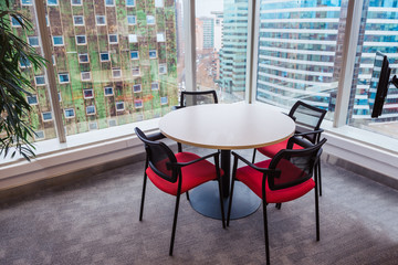 Meeting table right beside a big window, with a beautiful view of the city.