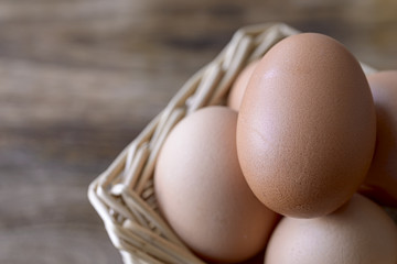 eggs in basket over wood