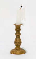 Obraz na płótnie Canvas Used white candle on candlestick