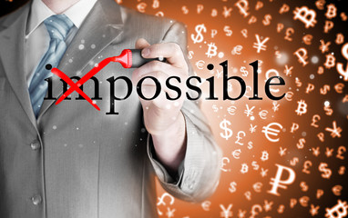 Businessman Hand turning the word Impossible into Possible with