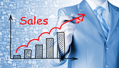 business man drawing graph of sales