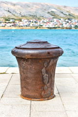 Naklejka premium Steel Mooring on a stone pier