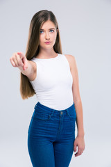 Female teenager pointing finger at camera