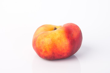 flat peaches (donut peaches) on a background