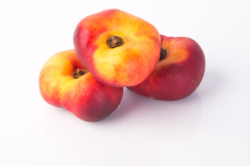 flat peaches (donut peaches) on a background