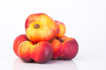 flat peaches (donut peaches) on a background