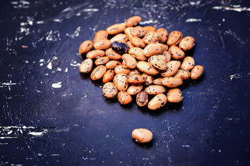 Dry pinto beans on old wooden background