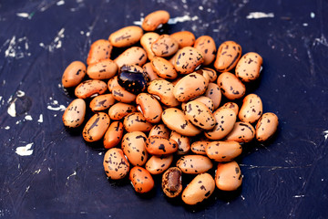 Dry pinto beans on old wooden background