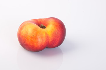 flat peaches (donut peaches) on a background