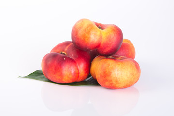 flat peaches (donut peaches) on a background