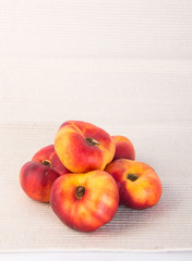 flat peaches (donut peaches) on a background