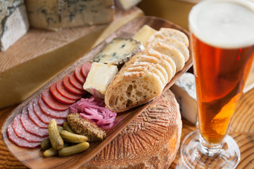 Bread, cheese and a tall glass of beer.