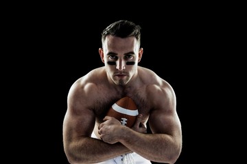 Fototapeta na wymiar Shirtless American football player with ball
