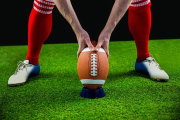 American football player preparing for a drop kick