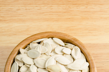 Fototapeta na wymiar dried pumpkin seeds, on wooden background