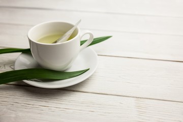 Cup of herbal tea on table