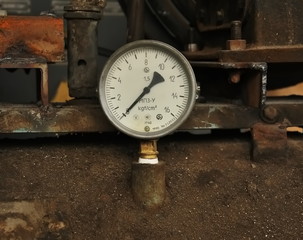 Old manometer with white scale and black arrow