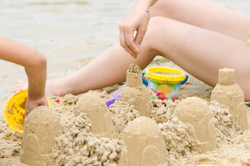 The girl on the beach building a castle