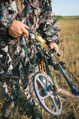 Hunter in camouflage with his bow 
