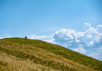 Obraz na płótnie Canvas Hiker sitting on top of a mountain