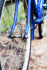 Wheel Old blue bike standing near the  wall