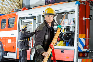 Confident Fireman Holding Wooden Stretcher