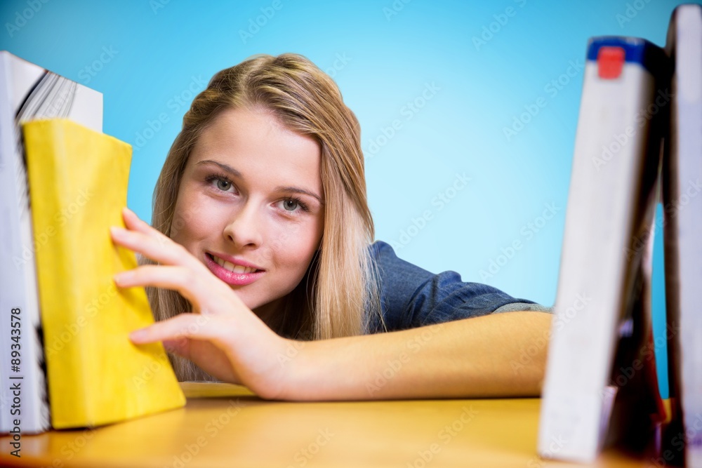 Canvas Prints Composite image of pretty student in the library