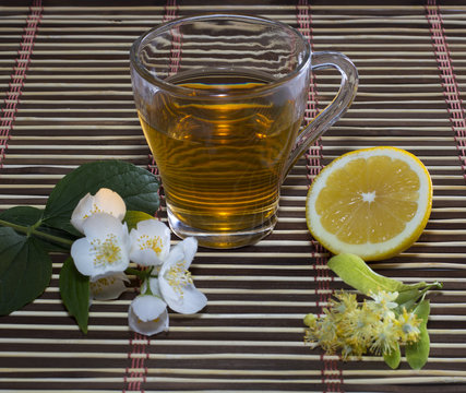 lime tea, lemon and flower on a decorative rug