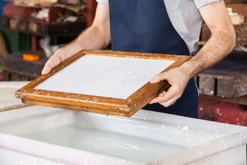 Worker Holding Mold At Paper Factory