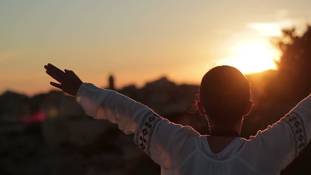 Happy woman open arms under the sunset, slow motion
