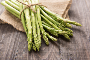 Bunch of fresh green asparagus on a rustic wooden table