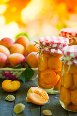Apricot in jars and basket, vertical