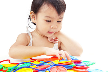 Closeup Asian Baby Girl Playing Threading Buttons Line Toy Isolated on White Background.