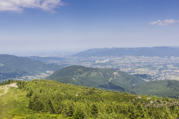 Fototapeta na wymiar Mountain landscape from Skrzyczne. Hillside covered with pine tr