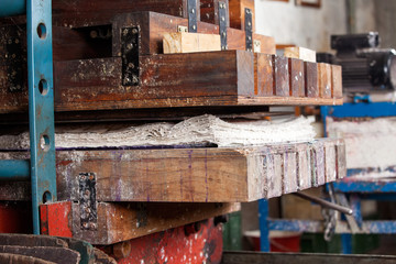 Fototapeta na wymiar Papers In Wooden Press Machine