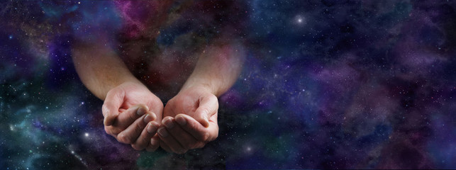 Our Abundant Universe - Male hands emerging from a wide dark deep space background gesturing with cupped hands - obrazy, fototapety, plakaty