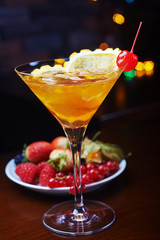 bright glass of delicious alcoholic martini cocktail or lemonade with ice and a slice of orange