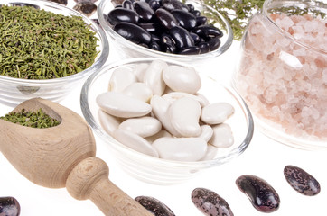  lima beans in a glass bowl ,dried winter savory,Himalayan salt  on a white background,selective focus.