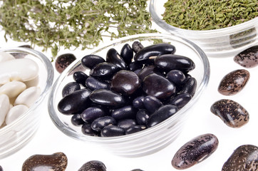  lima beans in a glass bowl ,dried winter savory  on a white background,selective focus.
