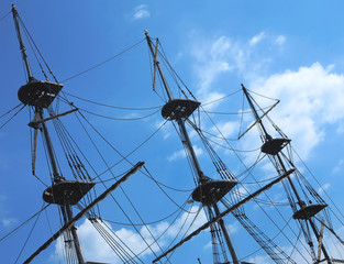 masts and rigging of a old sailing ship over blue sky