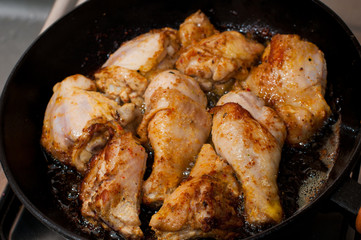 Frying pan with chicken legs inside