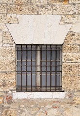 Old window in medieval stone wall