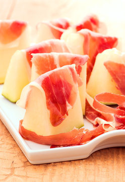 sweet melon with serrano ham cut on chips and sliced