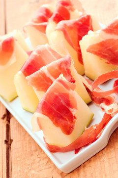 sweet melon with serrano ham cut on chips and sliced