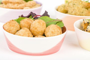 Party Food - Selection of prawn dishes on a wooden background. Prawn Toast, Prawn Popcorn, Butterfly Prawn and Prawn Goujons.
