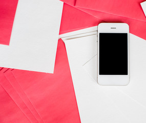Smartphone with white and red paper sheets